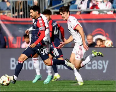  ?? File photo ?? Talented New England Revolution midfielder Carles Gil, left, signed an extension that will keep him with the team through 2026.