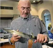  ?? Staff file photo ?? Phil Collins, seen in 2014, holds a Bowie knife, one of the items he donated to the Alamo’s museum.
