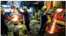  ?? NICK GRAHAM/STAFF ?? Employees dump molten brass into a ladle to be poured into molds at Hamilton Brass and Aluminum Castings Company in Hamilton in 2017. President Donald Trump recently announced he intends to impose tariffs on imported steel and aluminum, sparking fears...