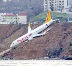  ??  ?? A Pegasus Airlines Boeing 737 passenger plane is seen struck in mud on an embankment, a day after skidding off the airstrip, after landing at Trabzon’s airport on the Black Sea coast. — AFP photo