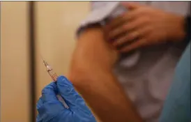  ?? LUCA BRUNO — THE ASSOCIATED PRESS FILE ?? A nurse prepares to inject flu vaccine in Milan, Italy on Nov. 4.