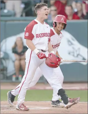  ?? NWA Democrat-Gazette/Andy Shupe ?? FIRST TEAM: Arkansas redshirt senior second baseman Carson Shaddy, front, celebrates with center fielder Dominic Fletcher after hitting a three-run home run on May 11 during the first inning of the Razorbacks’ 9-3 win against Texas A&M on May 11 in...