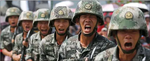  ??  ?? SHOW OF STRENGTH: Crack troops from China’s People’s Liberation Army put on a display of their aggression at a Hong Kong event last year