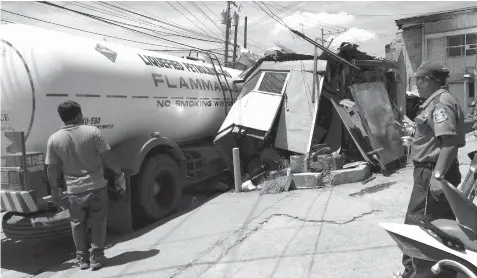  ?? JOY TORREJOS ?? A gas tanker rams into a carenderia in Canduman, Mandaue City yesterday morning. At least two people were injured during the incident.