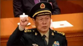  ?? AP ?? China’s defense minister, Gen. Wei Fenghe, pictured here being sworn into office, condemned U.S. Asia policy in Singapore this month.