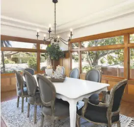  ?? Liz Rusby / The Grubb Co. ?? The formal dining room enjoys woodframed windows, crown molding and coffered wall paneling.