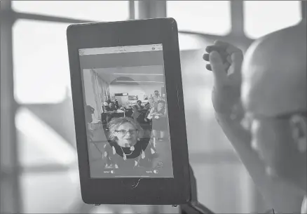  ?? BILL O'LEARY/THE WASHINGTON POST ?? Station Manager Chad Shane, right, of SAS airlines, ushers a boarding passenger through the process of biometric facial recognitio­n scanning in Dulles, Va.