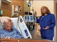  ?? THOMAS GNAU / STAFF ?? Julie Vincent (right), Kettering Health Network’s chief nursing officer and vice president of patient care, speaks with patient Jane Cox at Sycamore Medical Center recently. Nursing is a high-demand profession.