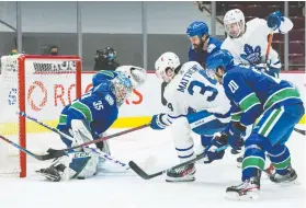  ?? BOB FRID/USA TODAY SPORTS ?? Thatcher Demko foils Leafs shooter Auston Matthews Thursday night. Matthews lauded the Canucks goalie after he backstoppe­d the Canucks to a 3-1 win.