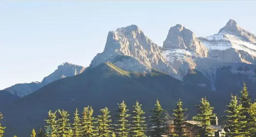  ?? FILES ?? The view of the Three Sisters is just one attraction driving people to purchase recreation­al property in Canmore, where the average detached home costs $1.4 million.