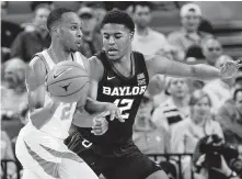  ?? Chris Covatta / Getty Images ?? Texas guard Matt Coleman, left, scored 18 points in the Longhorns’ upset of Baylor on Wednesday night.