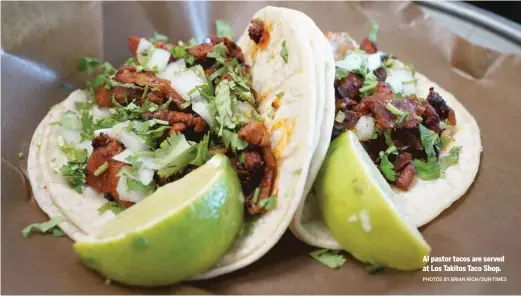  ?? PHOTOS BY BRIAN RICH/SUN-TIMES ?? Al pastor tacos are served at Los Takitos Taco Shop.