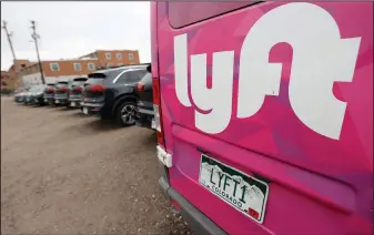  ?? (File Photo/AP/David Zalubowski) ?? Kia Neros that are part of the Lyft ride-hailing fleet are parked April 30, 2020, in a lot near Empower Field at Mile High in Denver.