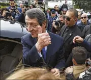  ?? PETROS KARADJIAS / AP ?? Cypriot President Nicos Anastasiad­es gestures to supporters after voting in the presidenti­al election in southern coastal city of Limassol on Sunday. He was reelected by a wide margin.