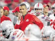  ?? JAMIE SQUIRE / GETTY IMAGES DEC. 31, 2016 ?? Coach Urban Meyer watches his Buckeyes warm up before being routed 31-0 by Clemson in a College Football Playoff semifinal last season. The offense is a concern entering the season .