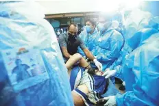  ?? AP ?? One of the injured passengers brought for treatment
■ to the Medical College Hospital in Kozhikode.