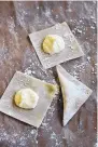  ?? MATTHEW MEAD/ASSOCIATED PRESS ?? Mound the cheese and almond filling onto wonton wrappers, then fold over to create triangles.