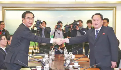  ??  ?? South Korea Unificatio­n Minister Cho Myung-Gyun (left) shakes hands with North Korean chief delegate Ri Son-Gwon during their meeting at the border truce village of Panmunjom in the Demilitari­zed Zone (DMZ) dividing the two Koreas. — AFP photo