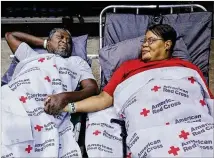  ?? CURTIS COMPTON/CCOMPTON@AJC.COM ?? Clarence and Virginia Robinson rest at the shelter at the Albany Civic Center to ride out Hurricane Irma. Albany officials had ordered a 5 p.m. curfew on Sunday. “I feel more safe here, and our street is already flooding,” Virginia said.