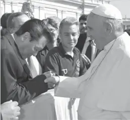  ?? ASSOCIATED PRESS ?? Pope Francis shakes hands with Japanese brain cancer specialist Dr. Takanori Fukushima on the occasion of a pope’s general audience in St. Peter’s Square at the Vatican.