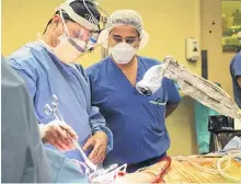  ?? UNIVERSITY HEALTH NETWORK ?? Dr. Marcelo Cypel, left, surgical director at the Ajmera Transplant Centre at Toronto General Hospital who led the team that performed the double-lung transplant, speaks with Dr. Shaf Keshavjee, director of the Toronto Lung Transplant Program, during a procedure on another patient.