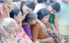  ?? — AFP ?? Sunayana Dumala (R), wife of killed engineer Srinivas Kuchibhotl­a is consoled by family members prior to performing the last rites at his funeral in Hyderabad on Tuesday.