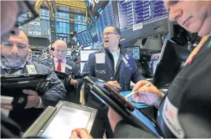  ?? RICHARD DREW THE ASSOCIATED PRESS ?? Traders react to market movements on Wednesday on the floor of the New York Stock Exchange.