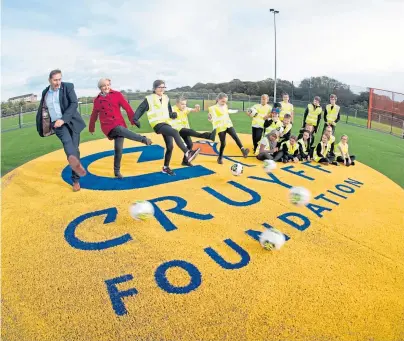  ??  ?? KICK OFF: Council co-leaders Douglas Lumsden and Jenny Laing try out the Cruyff facility with Tullos pupils