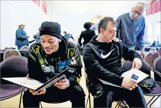  ?? [ERIC ALBRECHT/DISPATCH] ?? Joshua Allen, left, and Greg Hoff look over their certificat­es after graduating from vocational training through IMPACT Community Action and the National Skilled Trades Network on Thursday. The program prepares them for good-paying jobs in the constructi­on industry, which is starving for workers.