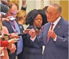  ?? STEVE HELBER/ASSOCIATED PRESS ?? Senate Minority Leader Chuck Schumer, D-N.Y., right, talks to the media as he returns to the Senate chamber Friday for the impeachmen­t trial of President Donald Trump. Schumer called the decision to end the trial without witness testimony ‘a tragedy on a very large scale.’