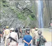  ?? HT PHOTO ?? Army and police personnel at the Siar Baba waterfall in Reasi, Jammu and Kashmir, where a boulder that fell from above crushed 7 people to death on Sunday.