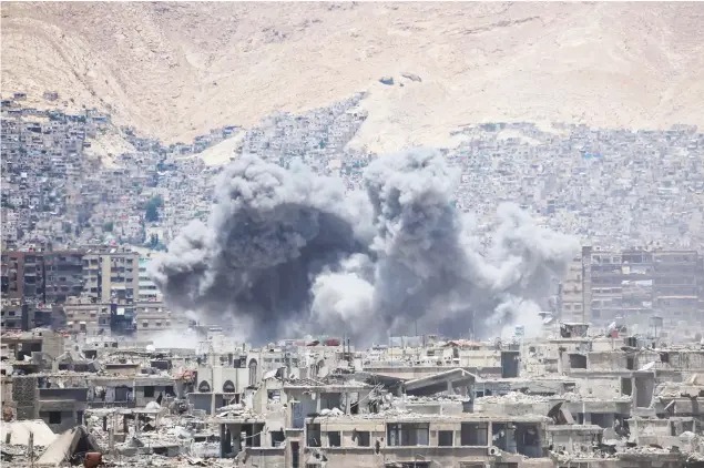  ??  ?? Smoke billows following a reported airstrike in the opposition-held parts of the Jobar district, on the eastern outskirts of the Syrian capital Damascus, on Sunday. (AFP)