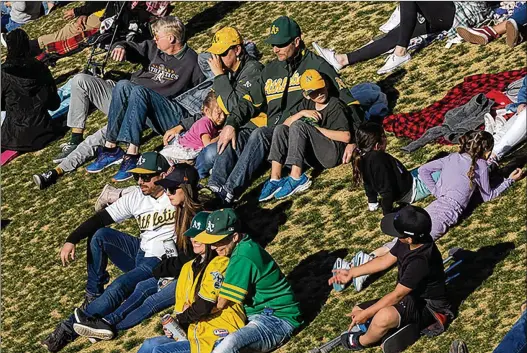  ?? ELLEN SCHMIDT/LAS VEGAS REVIEW-JOURNAL/TNS ?? Athletics fans watch from the outfield seating during a spring training game against the Reds at the Las Vegas Ballpark on Saturday. “The fans were great. They were loud. They came out. I think it was a sellout. It’s exciting to play in front of people that had a lot of energy,” says A’s manager Mark Kotsay.