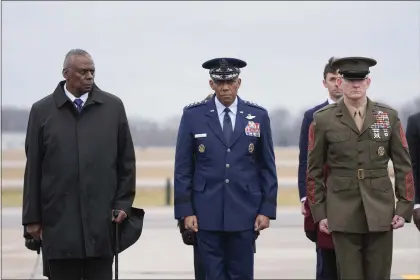  ?? ALEX BRANDON — THE ASSOCIATED PRESS ?? Defense Secretary Lloyd Austin, Chairman of the Joint Chiefs of Staff Gen. CQ Brown and Marine Corp. Sgt. Maj. Troy E. Black watch as an Army carry team moves the flag-draped transfer case containing the remains of U.S. Army Sgt. Kennedy Ladon Sanders, 24, of Waycross, Ga. during a casualty return at Dover Air Force Base, Del., Friday, Feb. 2, 2024. Sanders was killed in a drone attack in Jordan on Jan. 28.