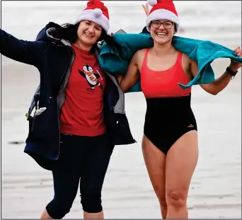  ?? ?? chilly: Alison O’Hanlon snapped Joanna and Anna Truchell at the Portmarnoc­k Beach Christmas Day swim