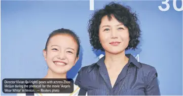  ??  ?? Director Vivian Qu (right) poses with actress Zhou Meijun during the photocall for the movie ‘Angels Wear White’ in Venice. — Reuters photo