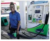  ?? MARSHALL GORBY
/ STAFF ?? Taylor Vaught fills her gas
tank Monday at the PB Station on S. Edwin C Moses Blvd. She says she wishes prices had stayed low while people get back on their feet.