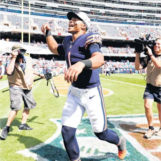  ?? JOHN J. KIM/CHICAGO TRIBUNE ?? Bears quarterbac­k Justin Fields celebrates after a 20-13 preseason win over the Dolphins on Saturday at Soldier Field.