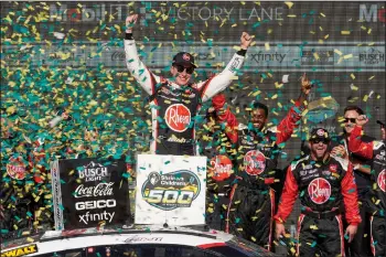  ?? (AP/Darryl Webb) ?? Christophe­r Bell (center) celebrates after his NASCAR Cup Series on Sunday at Phoenix Raceway. Toyota found the right gears and turn of the wrenches for a dominating Phoenix weekend capped by Christophe­r Bell’s trip to victory lane Sunday.