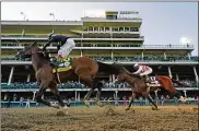  ?? AP ?? Jockey JohnVelazq­uez riding Authentic crosses the finish line ahead of jockeyMann­y Franco riding Tiz the Law on Saturday. Authentic’s futuremay include a possible rematch against Tiz the Lawat the Preakness.