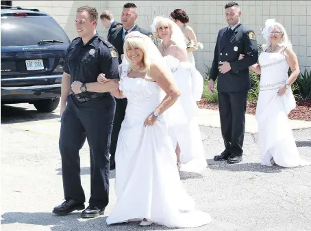  ?? PHOTOS: NICK BRANCACCIO ?? Local ‘Royal Wedding’ couples Carlton Ylinen and Linda Hill, front, Tim Samson and Marian Mills, and Dan Sementilli and Betty Gilbert, right, walk down the aisle during the Old Bats with Red Hats event at the Serbian Centre on Thursday.