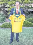  ?? AFP ?? New South Wales minister Stuart Ayres poses with a Wallabies jersey.