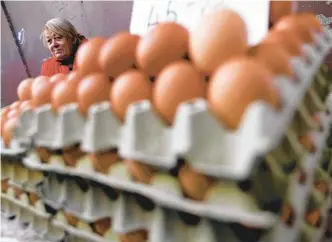  ?? LASZLO BALOGH AP ?? Vendor Judit Sos sells eggs in a food market in Budapest, Hungary. Rising prices have been most pronounced in the developing economies of central and eastern Europe.