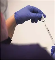  ?? Tyler Sizemore / Hearst Connecticu­t Media ?? Carly Plymel, RN, preps a dose of the Pfizer COVID-19 vaccine at the Stamford Health Vaccinatio­n Super Site in Stamford on April 6.