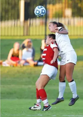  ?? STAFF FILE PHOTO BY C.B. SCHMELTER ?? East Hamilton’s Julia Kaset, right, goes for the ball against Baylor’s Mya McGee at East Hamilton Middle/High School on Sept. 26.