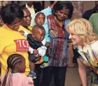  ?? DIRK HEINRICH/AP ?? U.S. first lady Jill Biden, right, talks with families Thursday during a visit to a U.S. President’s Emergency Plan for AIDS Relief project at an informal settlement near Windhoek, Namibia.