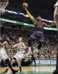  ?? ELISE AMENDOLA - THE ASSOCIATED PRESS ?? In this May 25 photo, Cleveland Cavaliers forward LeBron James (23) soars to the basket over Boston Celtics forward Jae Crowder, left, and center Kelly Olynyk (41) during the second half of Game 5 of the NBA basketball Eastern Conference finals in...