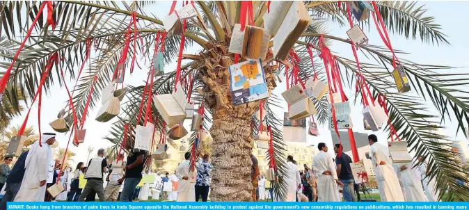  ??  ?? KUWAIT: Books hang from branches of palm trees in Irada Square opposite the National Assembly building in protest against the government’s new censorship regulation­s on publicatio­ns, which has resulted in banning many books from entering the country — Photo by Yasser Al-Zayyat