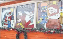  ?? MILLICENT MCKAY/JOURNAL PIONEER ?? “Santa’s Apprentice,” painted on the Winchester­s’ front windows.