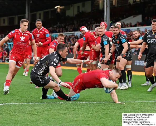  ?? ?? Rob Evans powers through the challenge of Sam Davies to score for the Scarlets at Rodney Parade last month.
Picture: Huw Evans Agency.